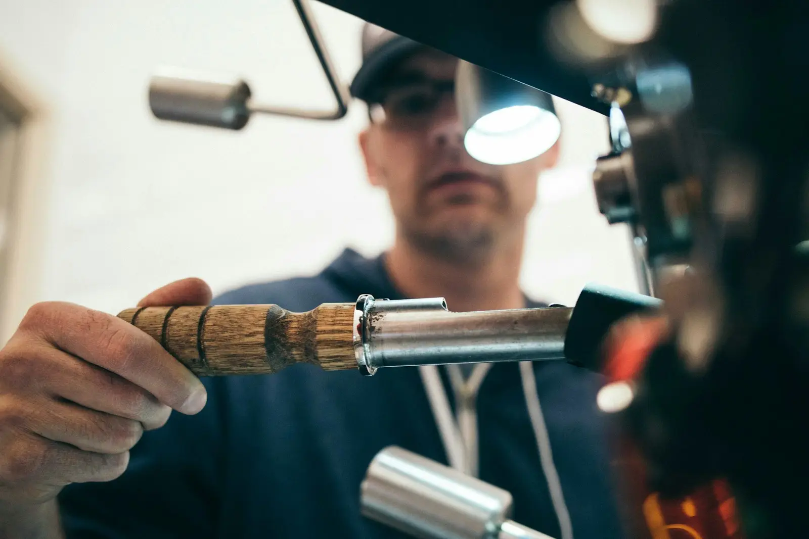 Technician checking a component under the shop lamp