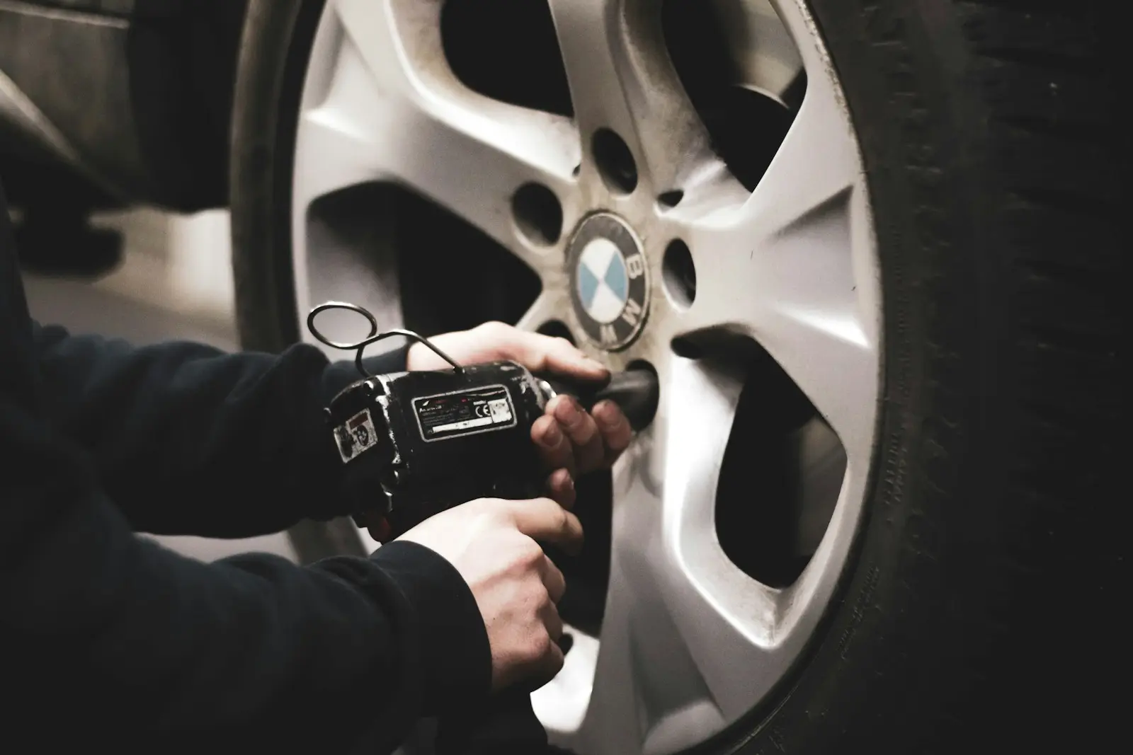 Technician torquing lug nuts on an alloy wheel