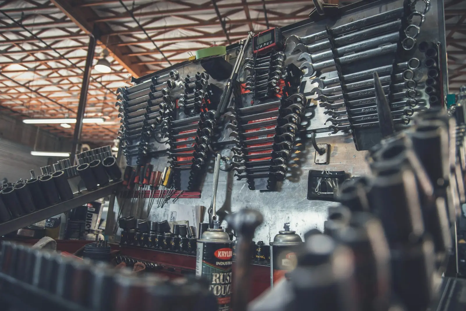 Wall of sockets and wrenches sorted by size above the workbench