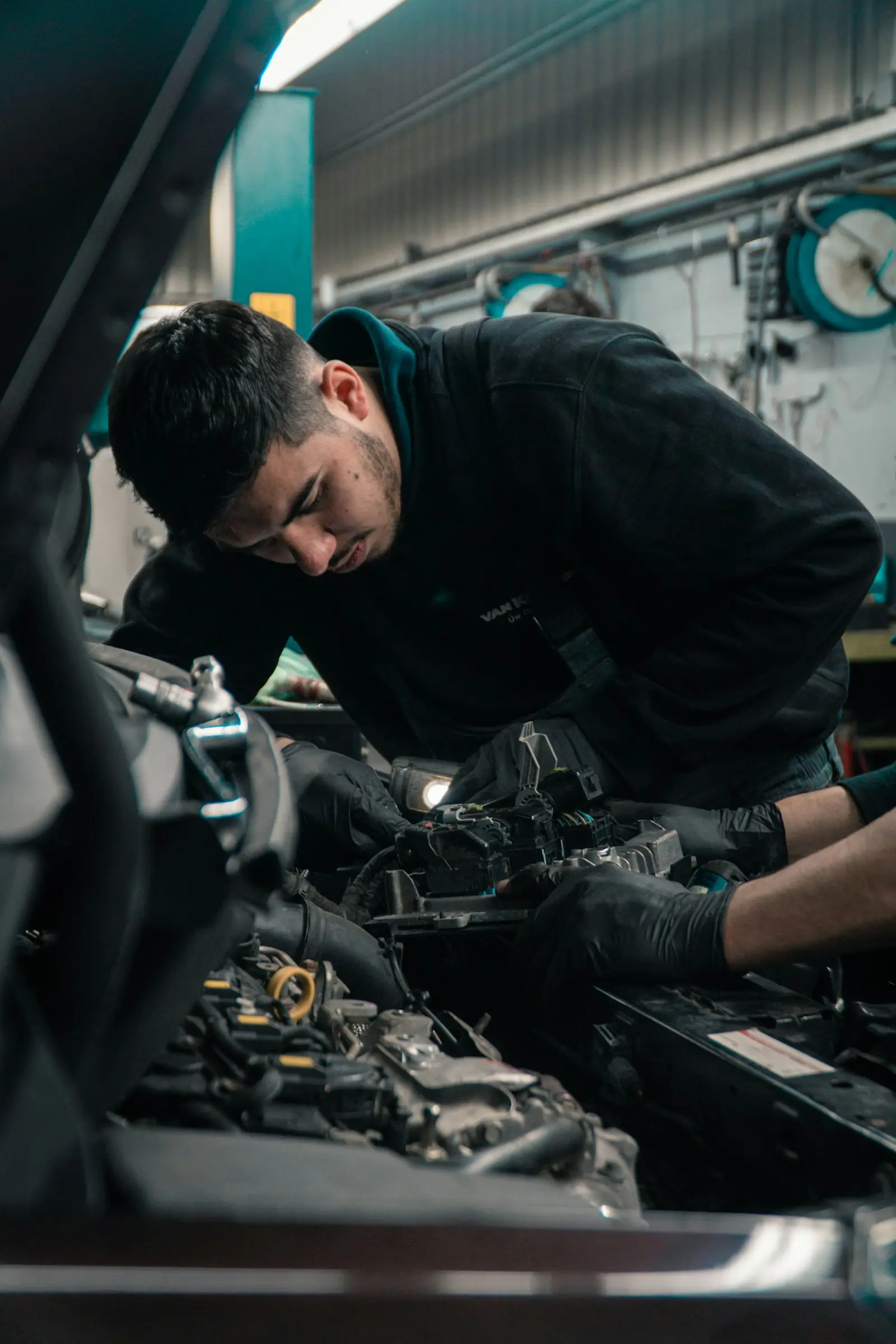 Technician in gloves working on an engine assembly
